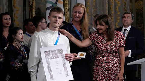 Paris mayor Anne Hidalgo, right, awards Ukrainian athletes Oleskii Sereda and Anastasiia Kozhenkova, center, during a ceremony at the 2024 Summer Olympics, Thursday, Aug. 1, 2024, in Paris, France. 