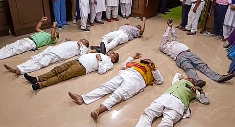 Jharkhand BJP MLAs lie on the floor during their protest inside the Jharkhand Legislative Assembly during the Monsoon session, in Ranchi, Wednesday, July 31, 2024.  