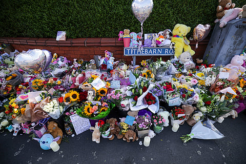 Flowers and toys are placed on the junction of Tithebarn Road and Hart Street in Southport, England, Wednesday, July 31, 2024, after three girls killed in a knife attack at a Taylor Swift-themed holiday club 