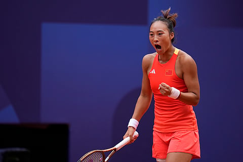 China's Zheng Qinwen clenches her fist as she plays Croatia's Donna Vekic during the women's singles tennis final (Photo | AP)