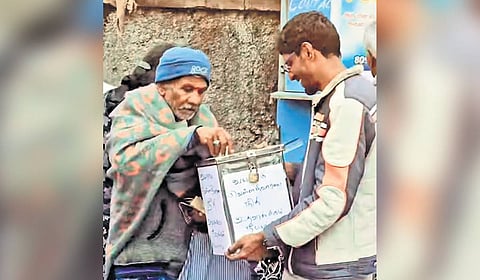 A youngster collects money from a man in Ooty as part of the ‘We Stand with Wayanad’ initiative 