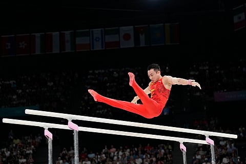 Zou Jingyuan, of China, competes during the men's artistic gymnastics individual parallel bars finals at Bercy Arena at the 2024 Summer Olympics.