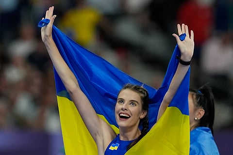 Yaroslava Mahuchikh, of Ukraine, celebrates winning the gold medal in women's high jump at the 2024 Summer Olympics, Sunday, Aug. 4, 2024, in Saint-Denis, France. 