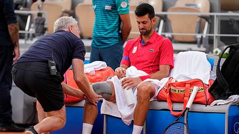 Serbia's Novak Djokovic receives medical treatment during his match against against Stefanos Tsitsipas of Greece during their men's quarter-final match at the Roland Garros stadium.