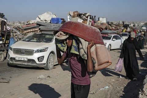 A Palestinian youth flees the Khan Younis area of the Gaza Strip, following Israeli military evacuation orders  saying its forces will soon operate there, Thursday, August 8, 2024.