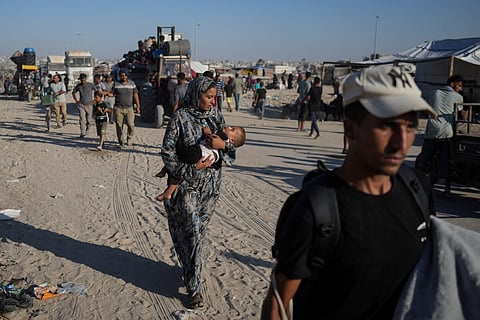 Palestinians flee the Khan Younis area of the Gaza Strip, following Israeli military evacuation orders, saying its forces will soon operate there, Thursday, Aug. 8, 2024.