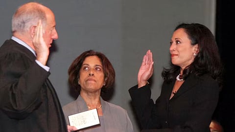 Kamala Harris, right, San Francisco’s new district attorney, with her mother, Dr. Shyamala Gopalan, holding a copy of the Bill of Rights, takes the oath of office from California Supreme Court Chief Justice Ronald M. George during inauguration ceremonies on Jan. 8, 2004, in San Francisco. 