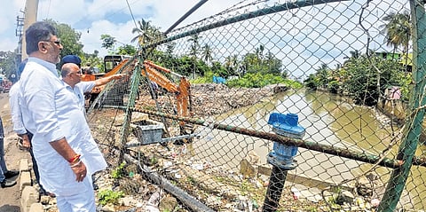 Deputy CM DK Shivakumar inspects a stormwater drain on Monday 