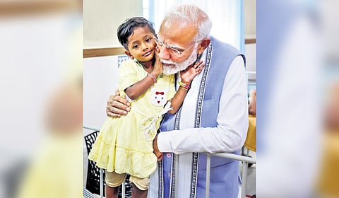 Prime Minister Narendra Modi shares a compassionate moment with Naisa at a hospital in Meppadi 