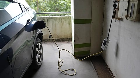 A car gets charged at the Electric Vehicle charging station at a residential building parking area in Mumbai