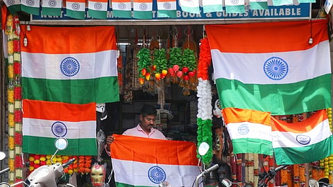 A worker at a flag shop ahead of Independence Day celebration