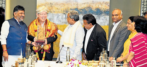 DyCM DK Shivakumar, Chief Minister Siddaramaiah, Industries Minister MB Patil and IT, BT Minister Priyank Kharge felicitate Foxconn CEO and chairman Young Liu in Bengaluru on Friday