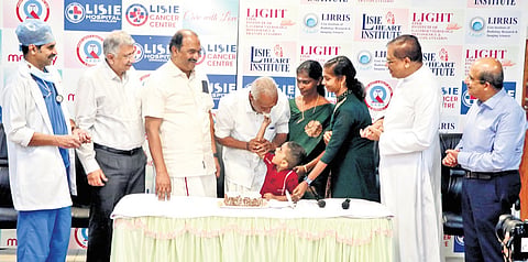 Shivan and his family celebrating 10th year of heart transplant with minister K N Balagopal, Dr Jose Chacko, Fr Paul Karedan and others