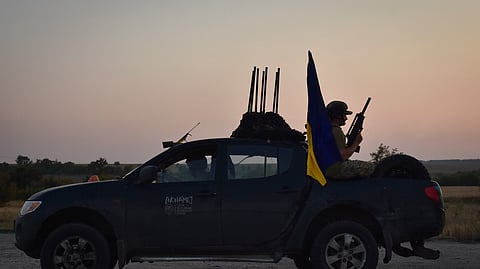A soldier of Ukraine's 141st separate infantry brigade rides in a pickup truck at the frontline in Zaporizhzhia region, Ukraine.
