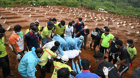 An unrecognised body is being buried at Puthumala. 