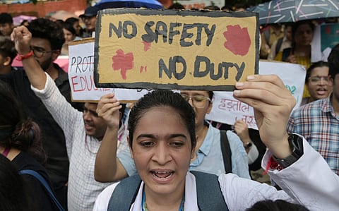 Doctors stage a protest against the brutal rape and murder of a postgraduate trainee doctor at Kolkata s RG Kar Hospital, at Jantar Mantar in New Delhi on Wednesday.