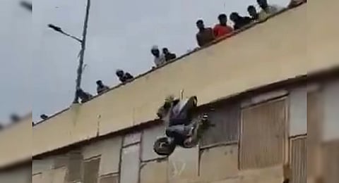 A video grab from the incident where people seen throwing a scooter from the flyover in Bengaluru.