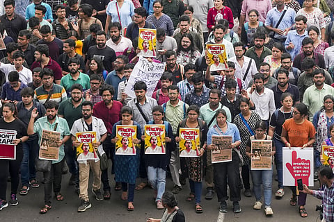  Doctors raise slogans during a protest rally over the recent alleged rape and murder of a trainee doctor at the RG Kar Medical College and Hospital, in Kolkata, Wednesday, Aug. 21, 2024.