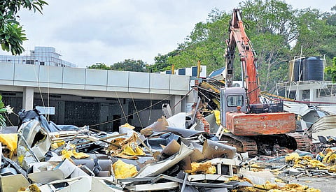 A JCB razes the N-Convention — owned by actor A Nagarjuna — for allegedly being constructed within the buffer zone of Thammidi Kunta lake, in Hyderabad on Saturday