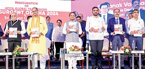 CM Mohan Charan Majhi releasing a souvenir at Resurgent Odisha-2024 