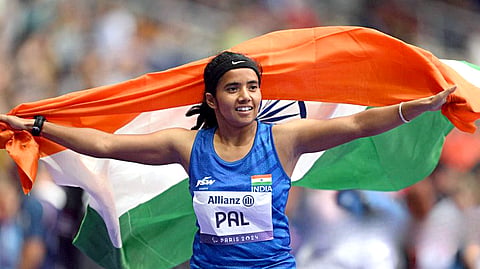 India's Preethi Pal holding the national flag celebrates her Bronze medal victory in the Women's 100m – T35 race, at the Paris Paralympics 2024, on Friday.