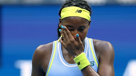 USA's Coco Gauff wipes her face after losing her women's singles round of 16 tennis match against USA's Emma Navarro on day seven of the US Open tennis tournament  on September 1, 2024.