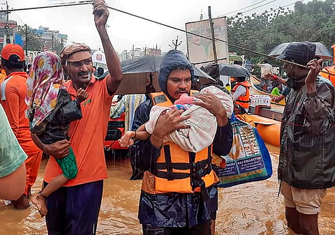 SDRF men rescue flood-hit people, in Ajit Singh Nagar, Vijayawada.