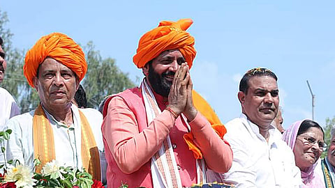 Haryana Chief Minister Nayab Singh Saini greets the gathering during a road show ahead of the upcoming assembly election, on Aug 28, 2024.