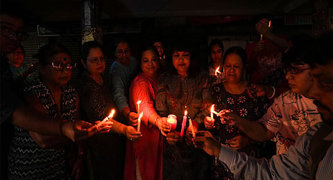 People stand during a candlelight vigil in protest against the alleged rape and murder of a trainee woman doctor at the RG Kar Medical College and Hospital, in Kolkata, Wednesday, Sept. 4, 2024.