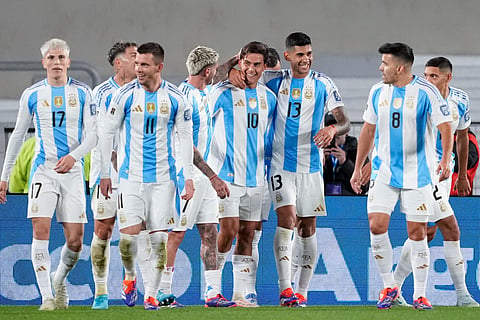 Teammates surround Argentina's Paulo Dybala (10) after he scored his side's third goal against Chile during a qualifying soccer match for the FIFA World Cup 2026 in Buenos Aires.