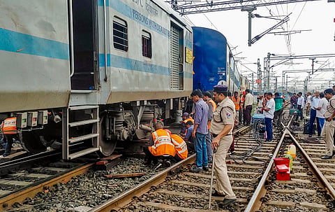 Railway officials gather after two compartments of the Indore-Jabalpur Express derail. 