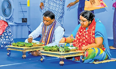 CM Mohan Charan Majhi and his wife Priyanka Marandi having local delicacies