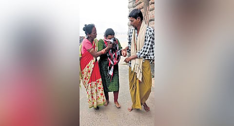 Behera and his wife Tukuni consoling a woman they rescued in Cuttack 
