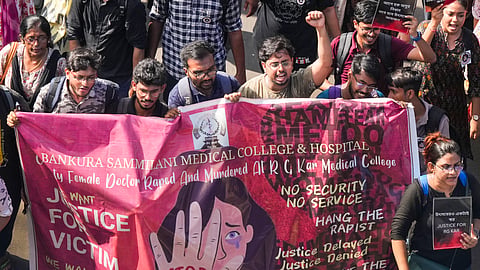 Junior doctors shout slogans as they march towards Swasthya Bhawan during a protest over RG Kar Hospital's rape and murder incident, in Kolkata.