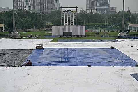 The covered ground is pictured after the one-off Test cricket match between Afghanistan and New Zealand, was called off due to rains, at the Shaheed Vijay Singh Pathik Sports Complex in Greater Noida on September 11, 2024. 