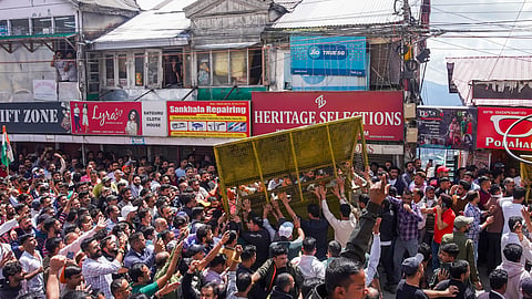 Protestors, who had gathered on the call of Hindu groups, remove a security barricade during a protest demanding the demolition of an illegal structure in a mosque, at Sanjauli locality in Shimla.