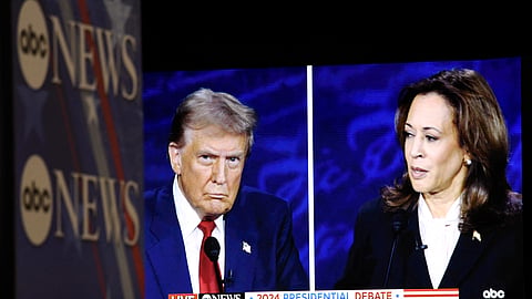 US Vice President and Democratic presidential candidate Kamala Harris and former US President and Republican presidential candidate Donald Trump are seen on a screen in the spin room as they participate in a presidential debate at the National Constitution Center in Philadelphia, Pennsylvania, on September 10, 2024.