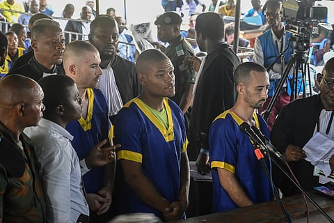 From left T,yler Thompson Jr, Marcel Malanga and Benjamin Reuben Zalman-Polun, all American citizens, face the court in Kinshasa with 52 other defendants on June 7, 2024, accused of a role in last month's attempted coup in Congo led by little-known opposition figure Christian Malanga in which six people were killed. 