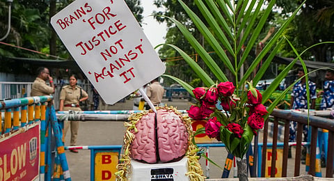 A replica of a human brain with a placard is placed on a barricade on the third day of the junior doctors' protest against the alleged rape and murder of a trainee woman doctor at RG Kar Medical College and Hospital, near Swasthya Bhawan, in Kolkata, Thursday, Sept. 12, 2024