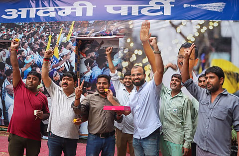  AAP workers celebrate after Delhi Chief Minister and party chief Arvind Kejriwal was granted bail by the Supreme Court in the now-scrapped Delhi excise policy case, in New Delhi, Friday, Sept. 13, 2024. 