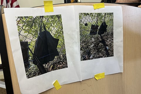 Photos that show an AK-47 rifle, a backpack and a Go-Pro camera on a fence outside Trump International Golf Club taken after an apparent assassination attempt of Republican presidential candidate former President Donald Trump, are displayed during a news conference at the Palm Beach County Main Library, Sunday. Sept. 15, 2024, in West Palm Beach, Fla.