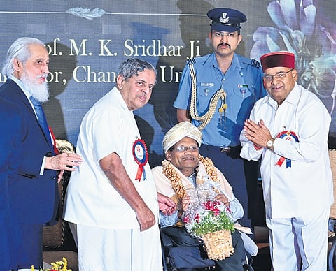 NAAC Executive Committee Chairman Prof Anil D Sahasrabudhe, S-Vyasa University Chancellor Dr H R Nagendra Guruji and Governor Thaawarchand Gehlot felicitate Chanakya University Chancellor Prof M K Sridhar in Bengaluru on Monday