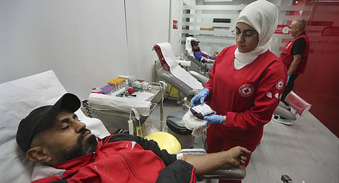 People donate blood for those who were injured by their exploded handheld pagers, at a Red Cross center, in the southern port city of Sidon, Lebanon, Tuesday, Sept. 17, 2024. 