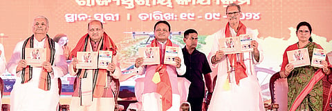 Chief Minister Mohan Charan Majhi, deputy CMs KV Singh Deo and Pravati Parida, BJP’s Odisha president Manmohan Samal and state in-charge VP Singh Tomar present the report card of the first 100 days of BJP government at a function in Puri, on Thursday 