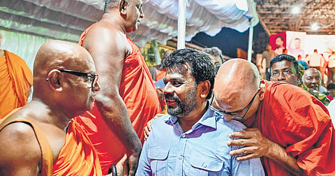 National People’s Power’s presidential candidate Anura Kumara Dissanayaka (3L), greets Buddhist monks during a rally in Colombo ahead of the Sept 21 poll.