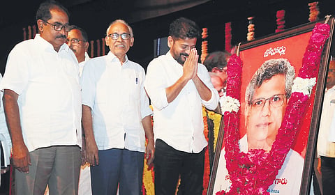 Chief Minister A Revanth Reddy pays floral tributes to 
a portrait of Sitaram Yechury during a memorial meeting organised at Ravindra Bharathi in Hyderabad on Saturday