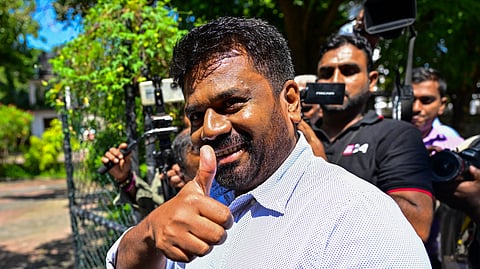 National People's Power (NPP) party's presidential candidate Anura Kumara Dissanayake (C) arrives at a polling station to cast his ballot during voting in Sri Lanka's presidential election in Colombo on September 21, 2024. 