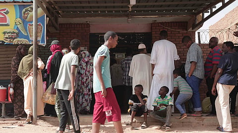People line up in front of a bakery during a cease-fire in Khartoum, Sudan, May 27, 2023. 