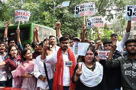 Supporters of DUSU candidate from NSUI throwing pamphlets in the air on last day campaign of DUSU Election. 