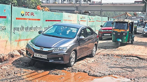 Vehicles struggling through potholes
